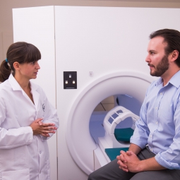researcher discusses MRI study with participant